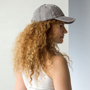 Woman wearing vintage unisex cotton twill cap with embroidered Ukrainian Tryzub, showcasing a trendy, lived-in style.