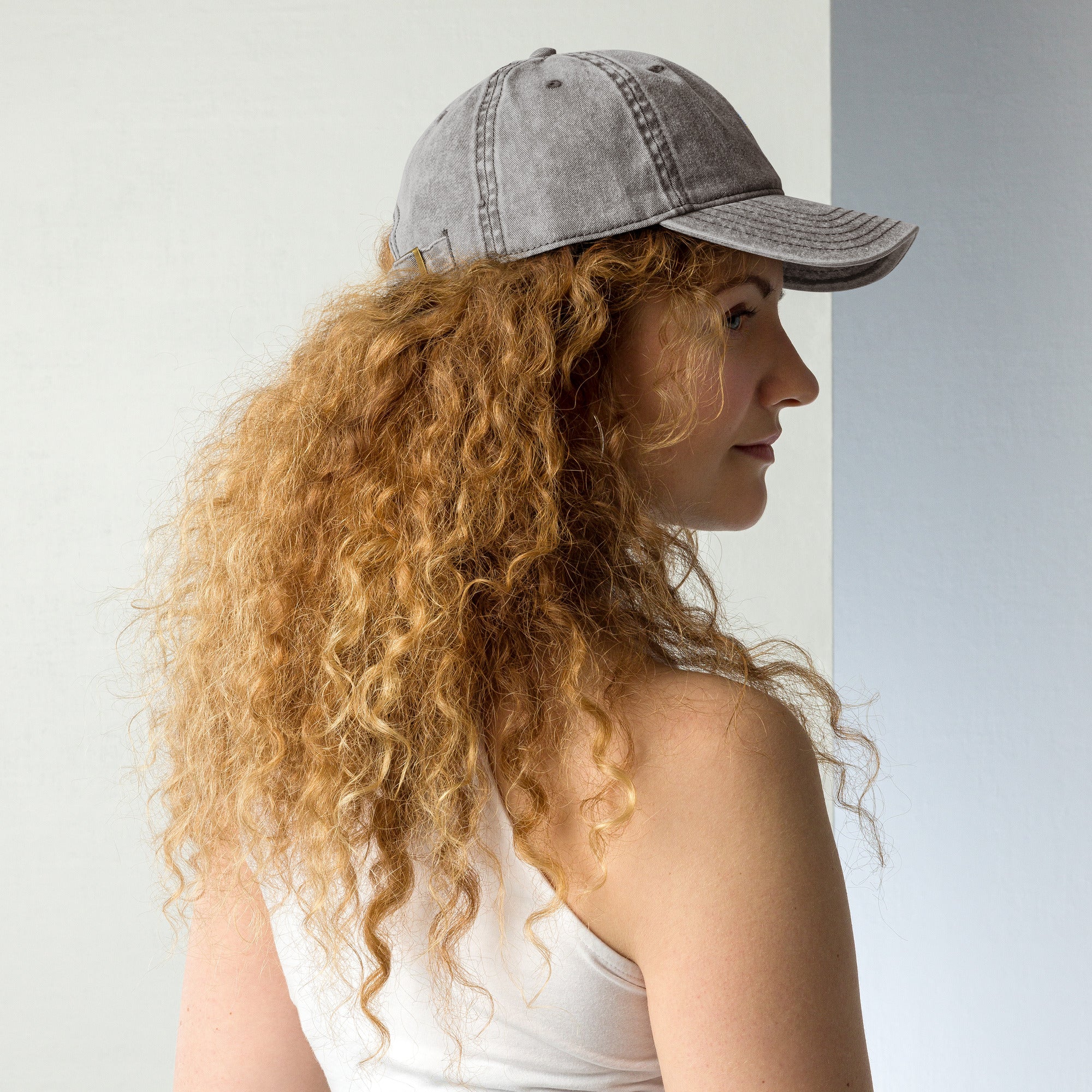 Woman wearing vintage unisex cotton twill cap with embroidered Ukrainian Tryzub, showcasing a trendy, lived-in style.