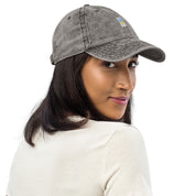 Woman wears vintage unisex cotton twill cap with embroidered Ukrainian Tryzub, showcasing trendy washed-out effect and relaxed fit.