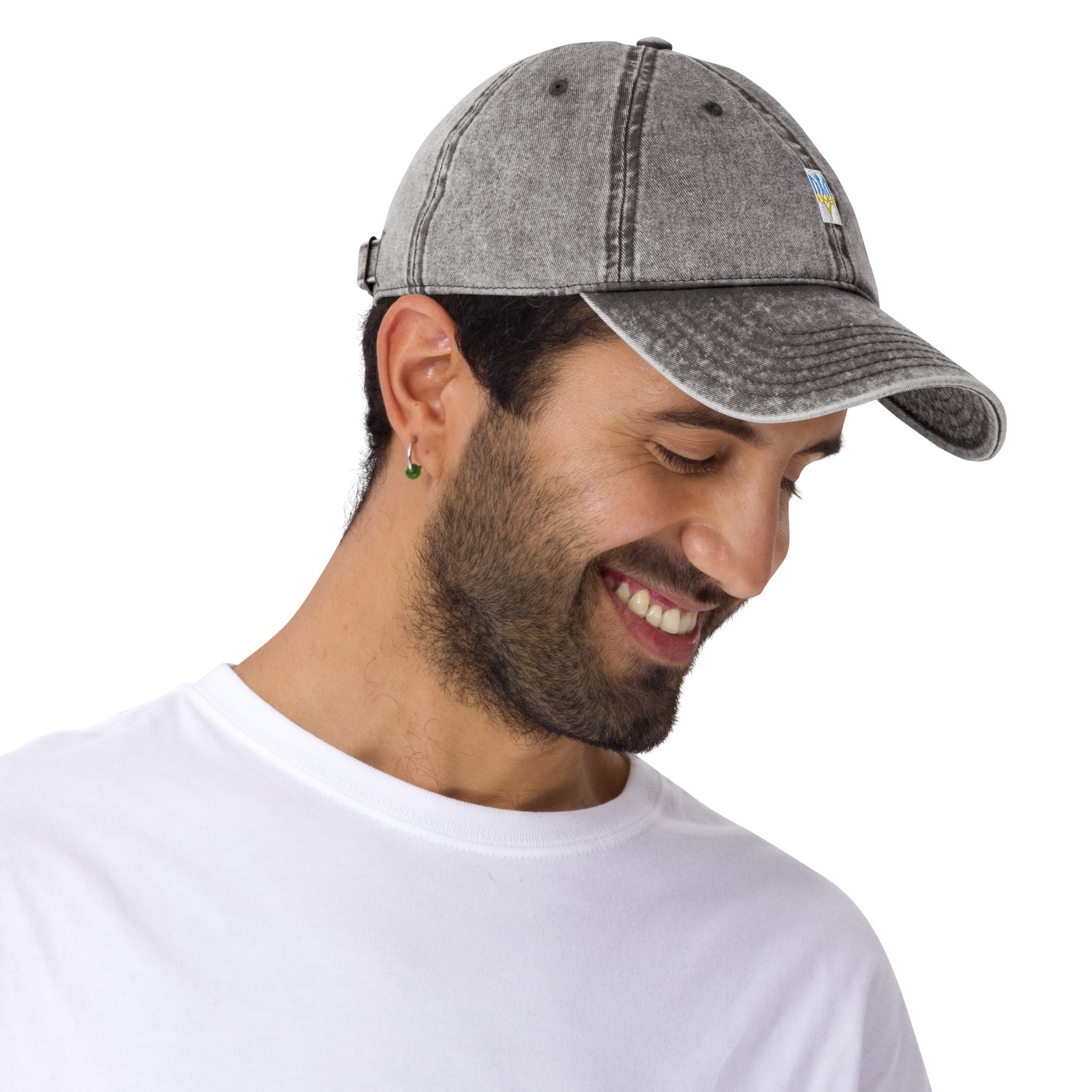 Man wearing vintage unisex cotton twill cap with embroidered Ukrainian Tryzub design, showcasing relaxed fit and adjustable brass buckle.