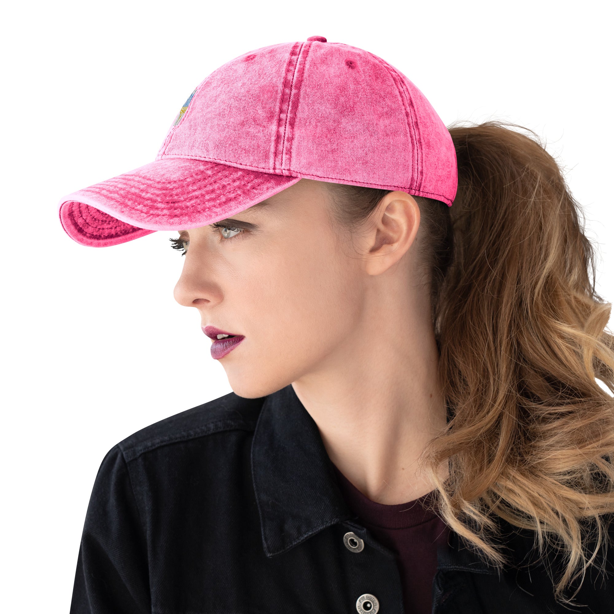 Unisex pink cotton twill cap with Ukrainian Tryzub embroidery, worn by a model, featuring a vintage washed-out design.