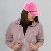 Woman wearing a pink vintage cotton twill cap with embroidered Ukrainian Tryzub, featuring a washed-out effect and adjustable fit.
