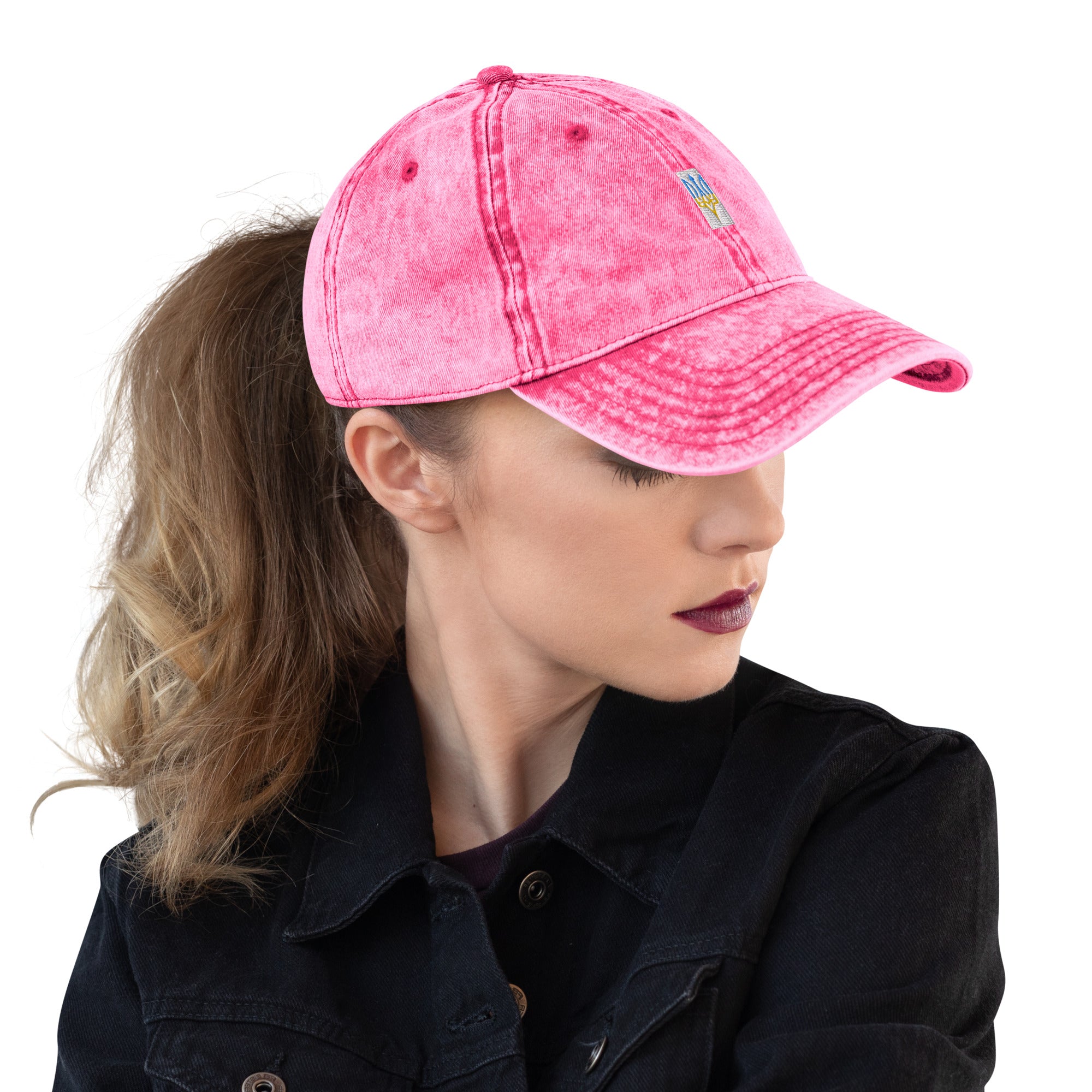 Woman wearing a pink vintage cotton twill cap with embroidered Ukrainian Tryzub, showcasing style and culture.