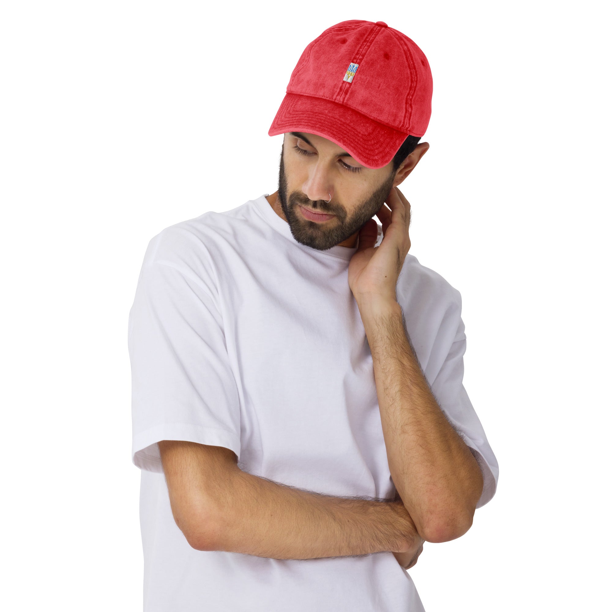 Red vintage unisex cotton twill cap with embroidered Ukrainian Tryzub, worn by man in white shirt, adjustable brass buckle visible.