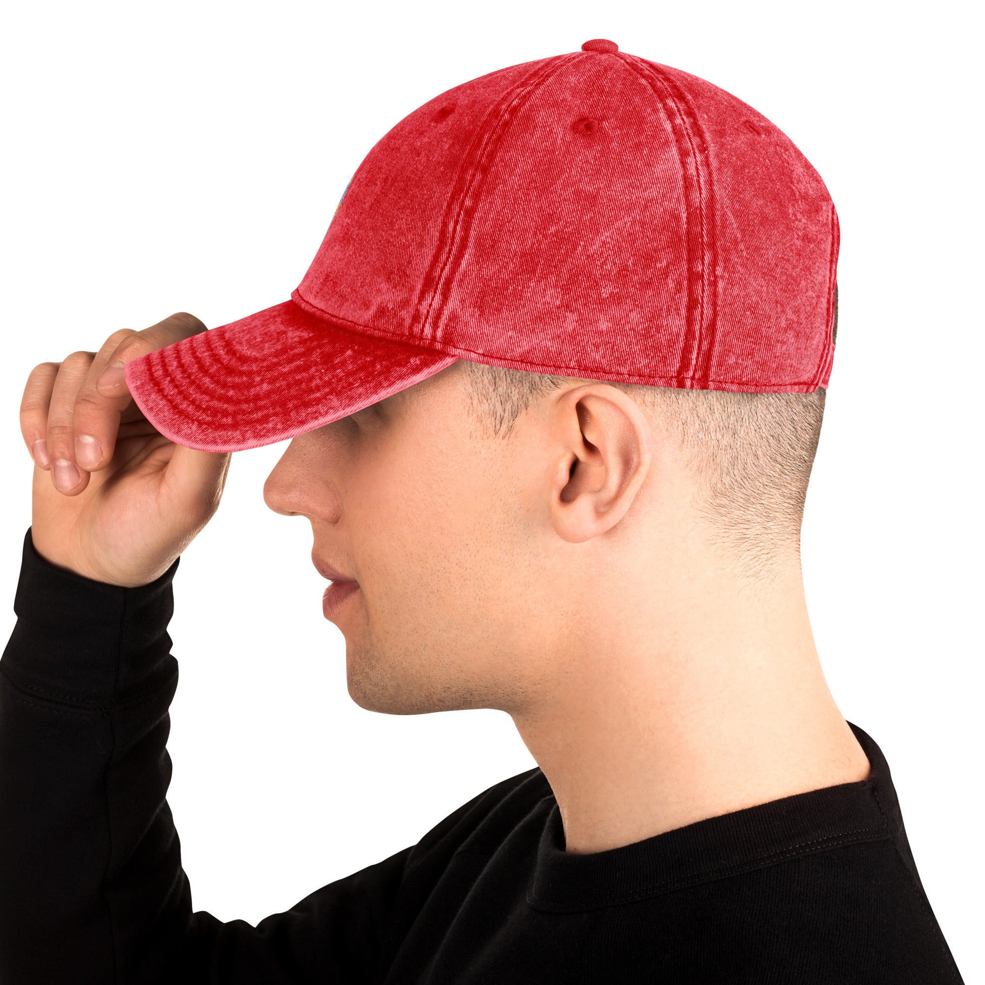 Man wearing a vintage red cotton twill cap featuring embroidered Ukrainian Tryzub design, side view.