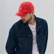 Man wearing red vintage unisex cotton twill cap with Ukrainian Tryzub embroidery, paired with a denim jacket.