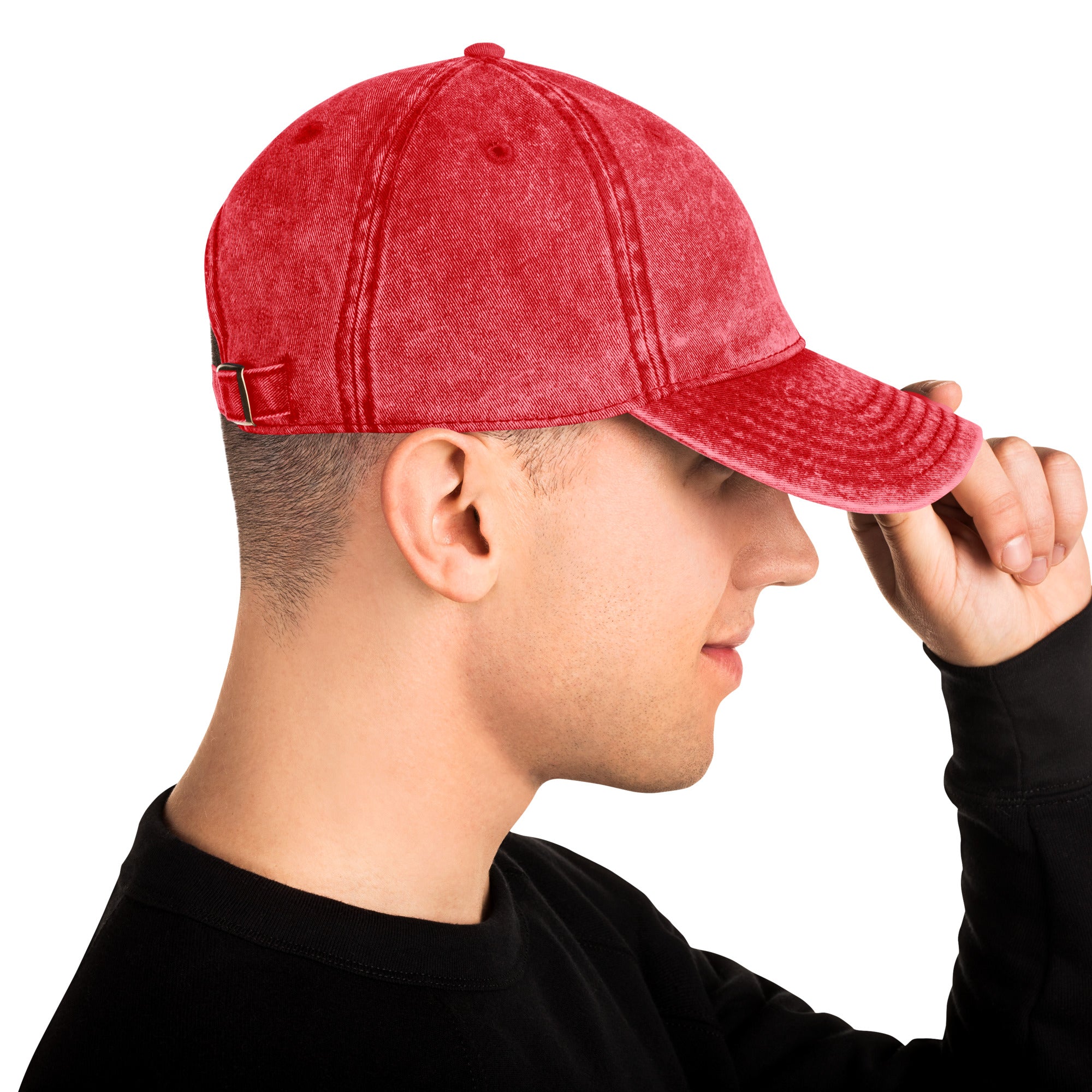 Red vintage cotton twill cap with Tryzub embroidery, showing adjustable brass buckle and washed-out effect on a person.