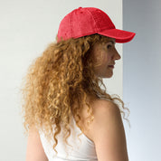 Woman wearing a red vintage cotton twill cap with embroidered Tryzub, showcasing a casual style and adjustable fit.