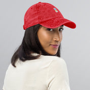 Woman wearing red vintage cotton twill cap with embroidered Ukrainian Tryzub design, showcasing fashionable and comfortable style.