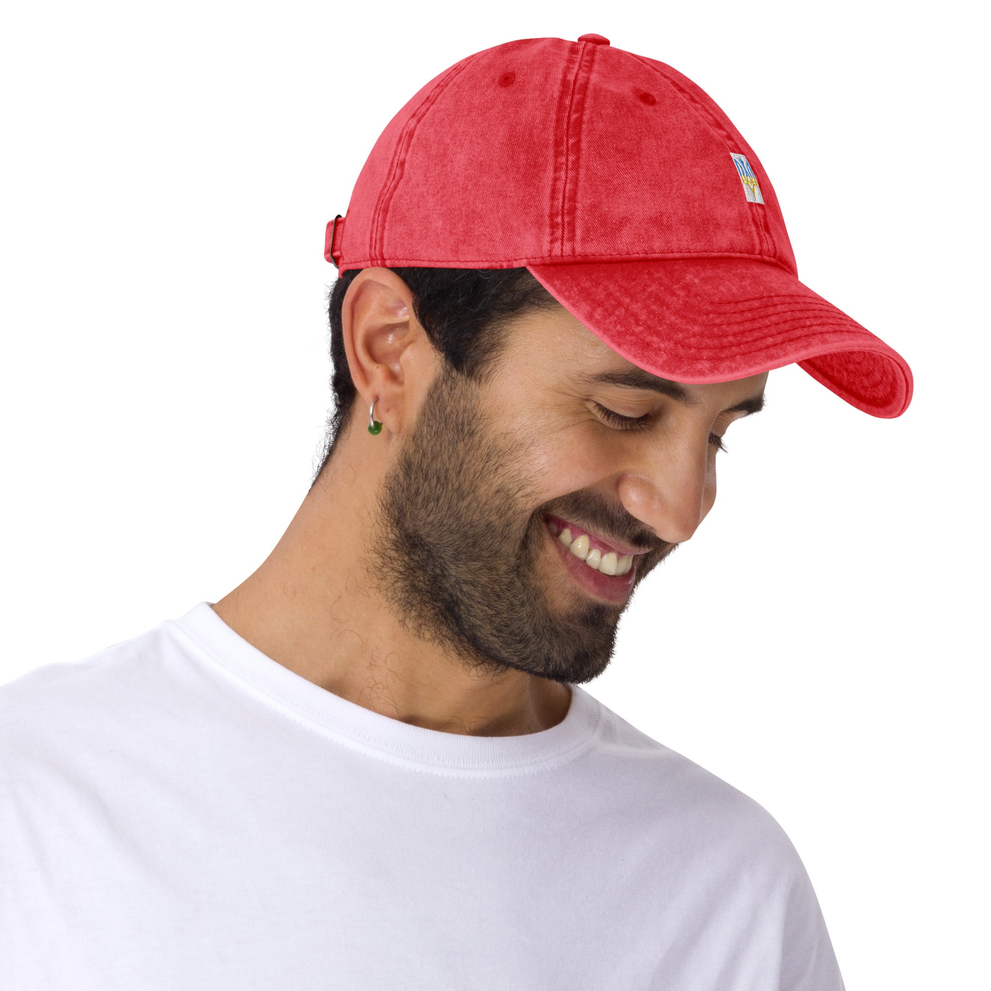 Smiling man wearing red vintage unisex cotton twill cap with embroidered Ukrainian Tryzub design.