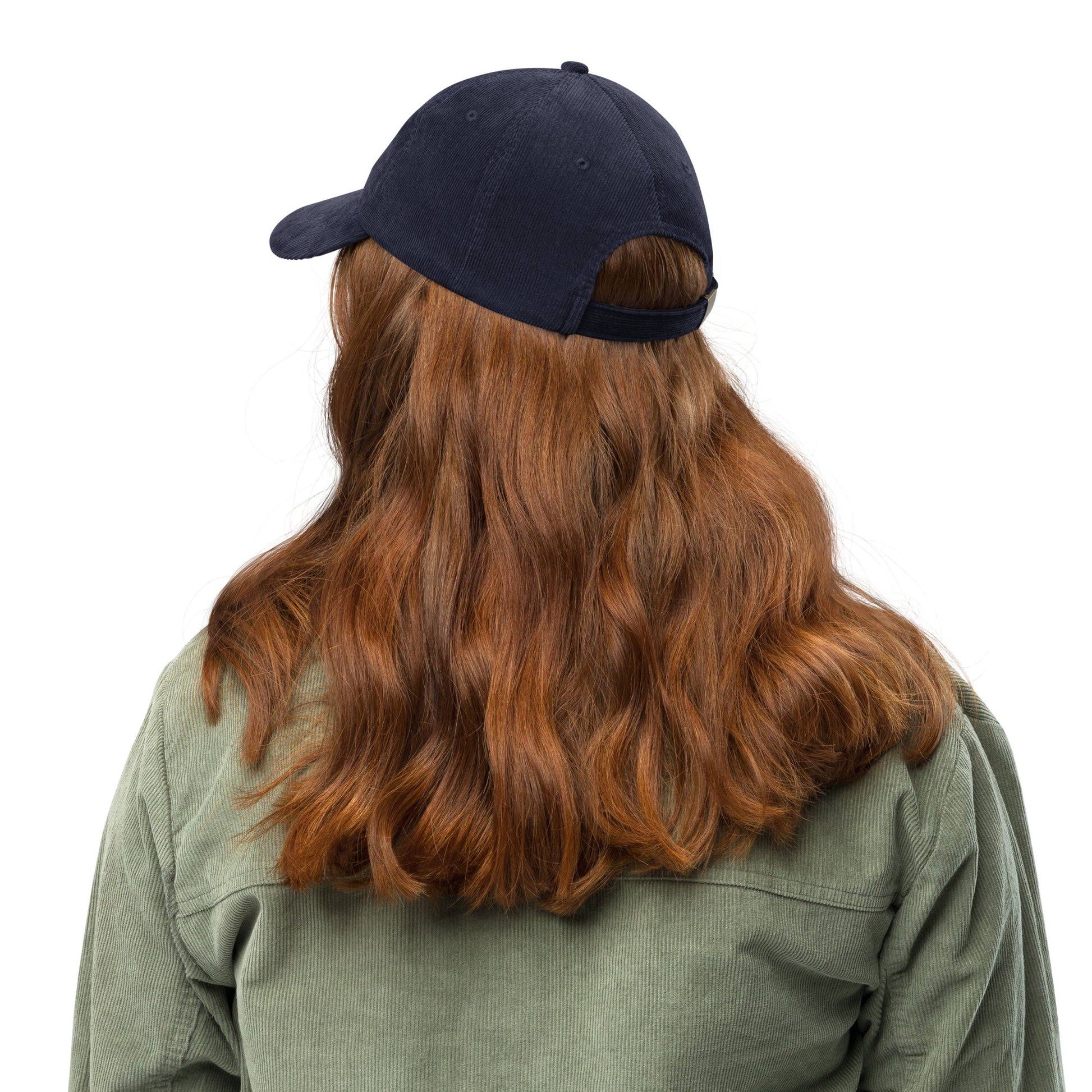 Person wearing a vintage corduroy cap with adjustable strap, showcasing back view and long hair.