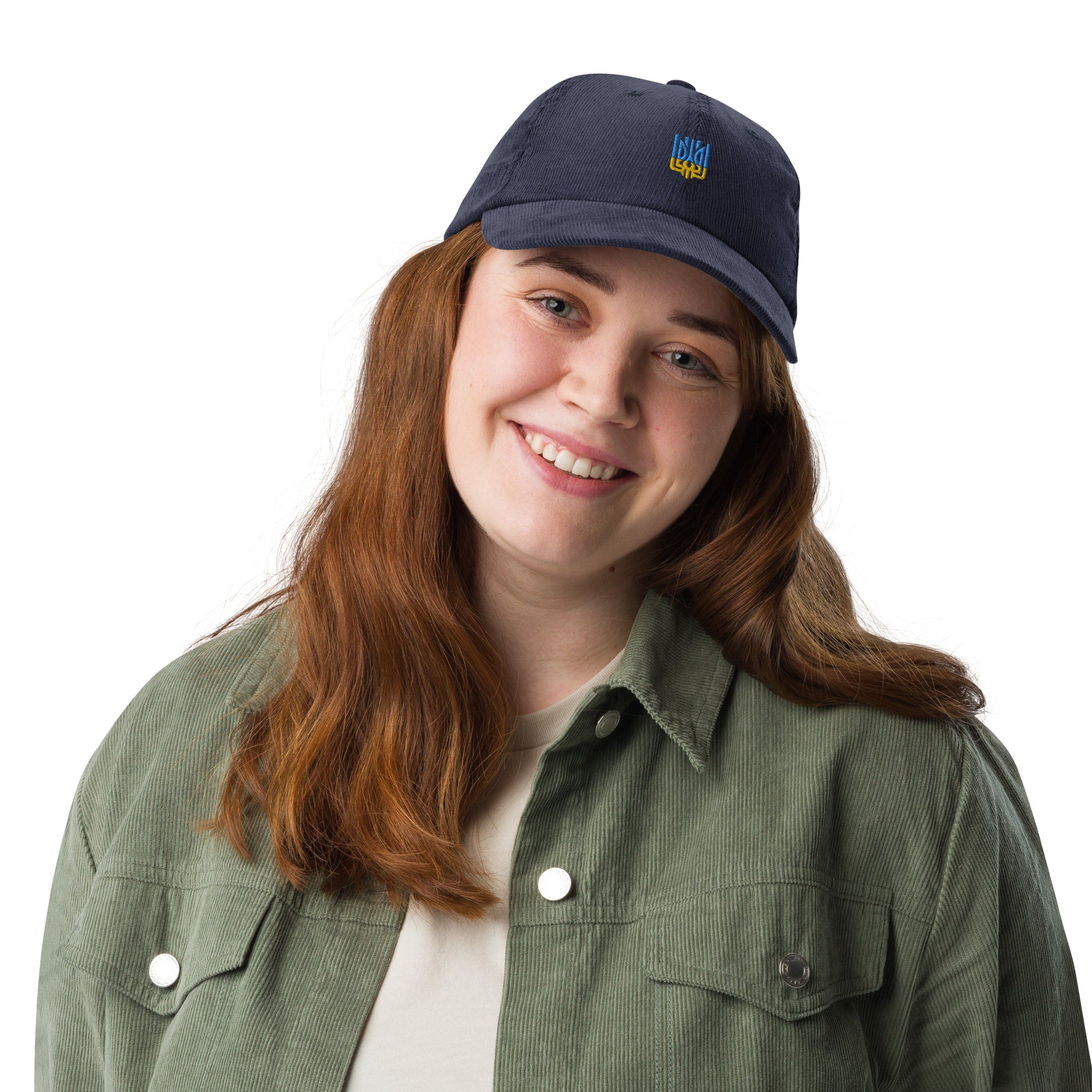 Woman wearing vintage corduroy cap with Ukrainian Tryzub, showcasing retro style and patriotic flair.