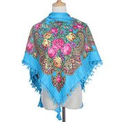 Vintage Ukrainian embroidered headscarf in blue with floral design displayed on mannequin.