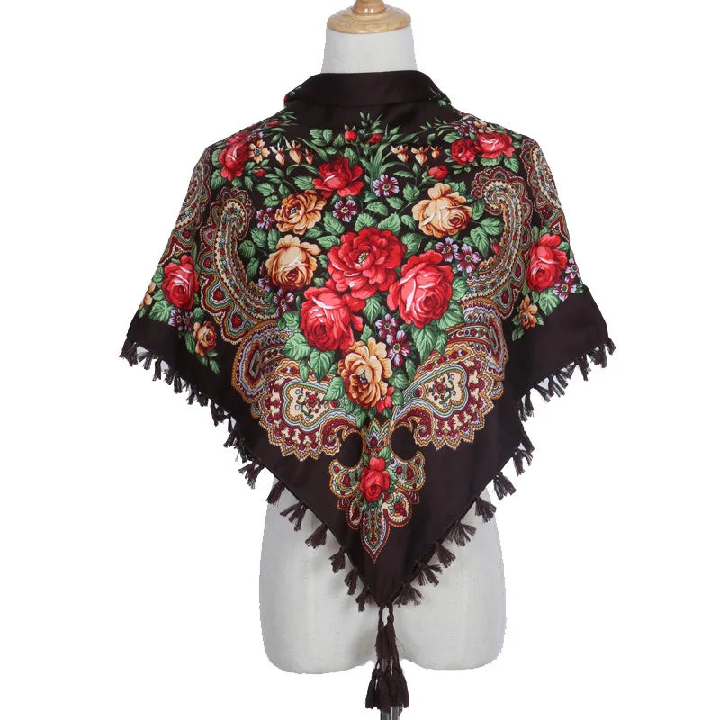 Vintage Ukrainian embroidered headscarf with floral design and tassels on display mannequin.
