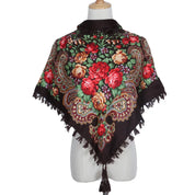 Vintage Ukrainian embroidered headscarf with floral design and tassels on display mannequin.