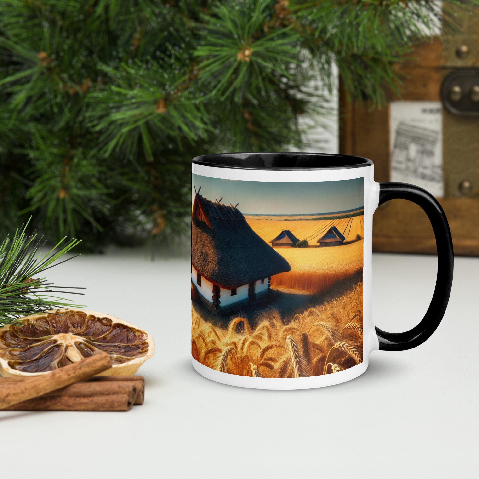 Ceramic mug with Ukrainian cottage and wheat field design, featuring a black rim and handle, against a festive background.