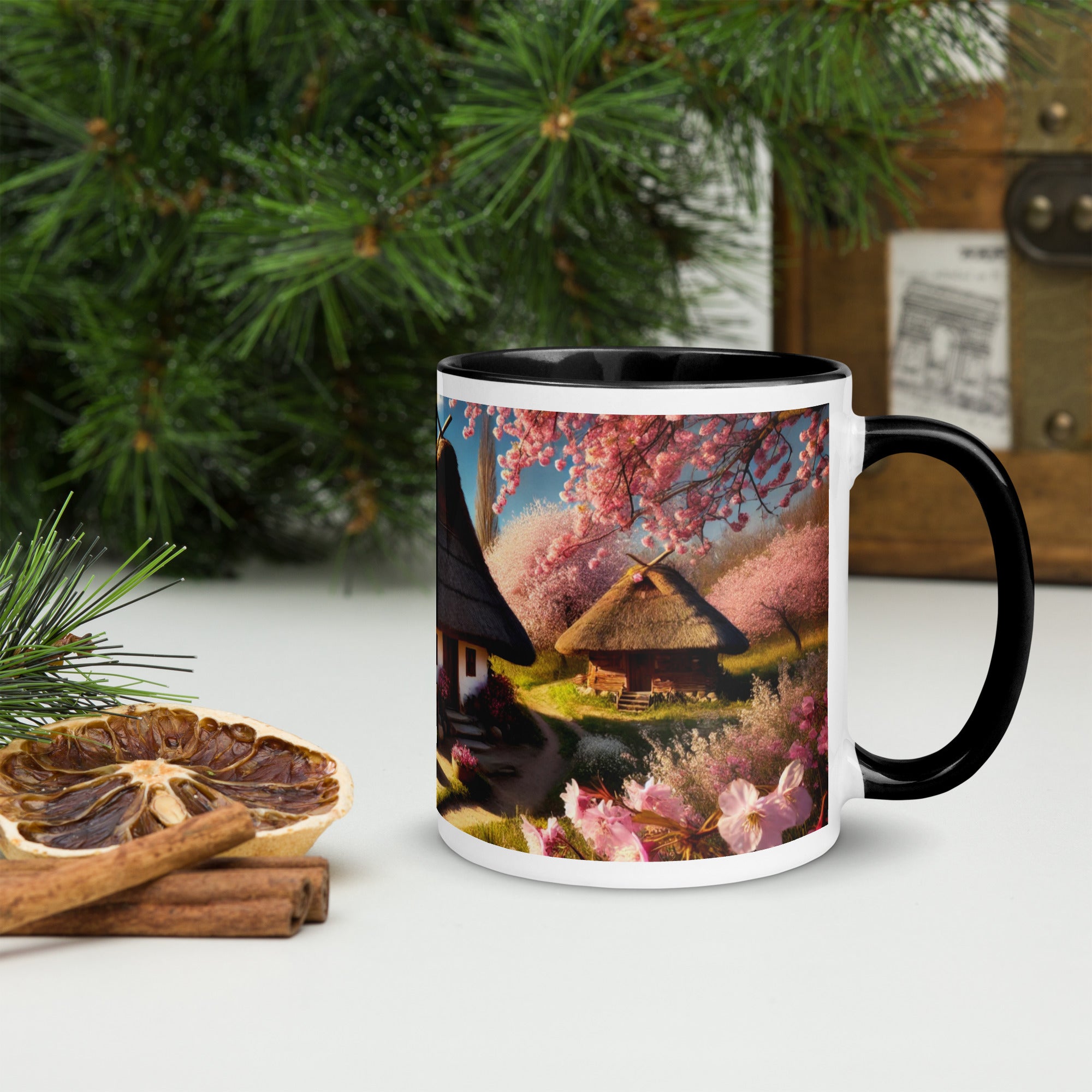Ceramic mug with Ukrainian cottage and cherry orchard design, black rim and handle, set against a festive background with dried citrus.