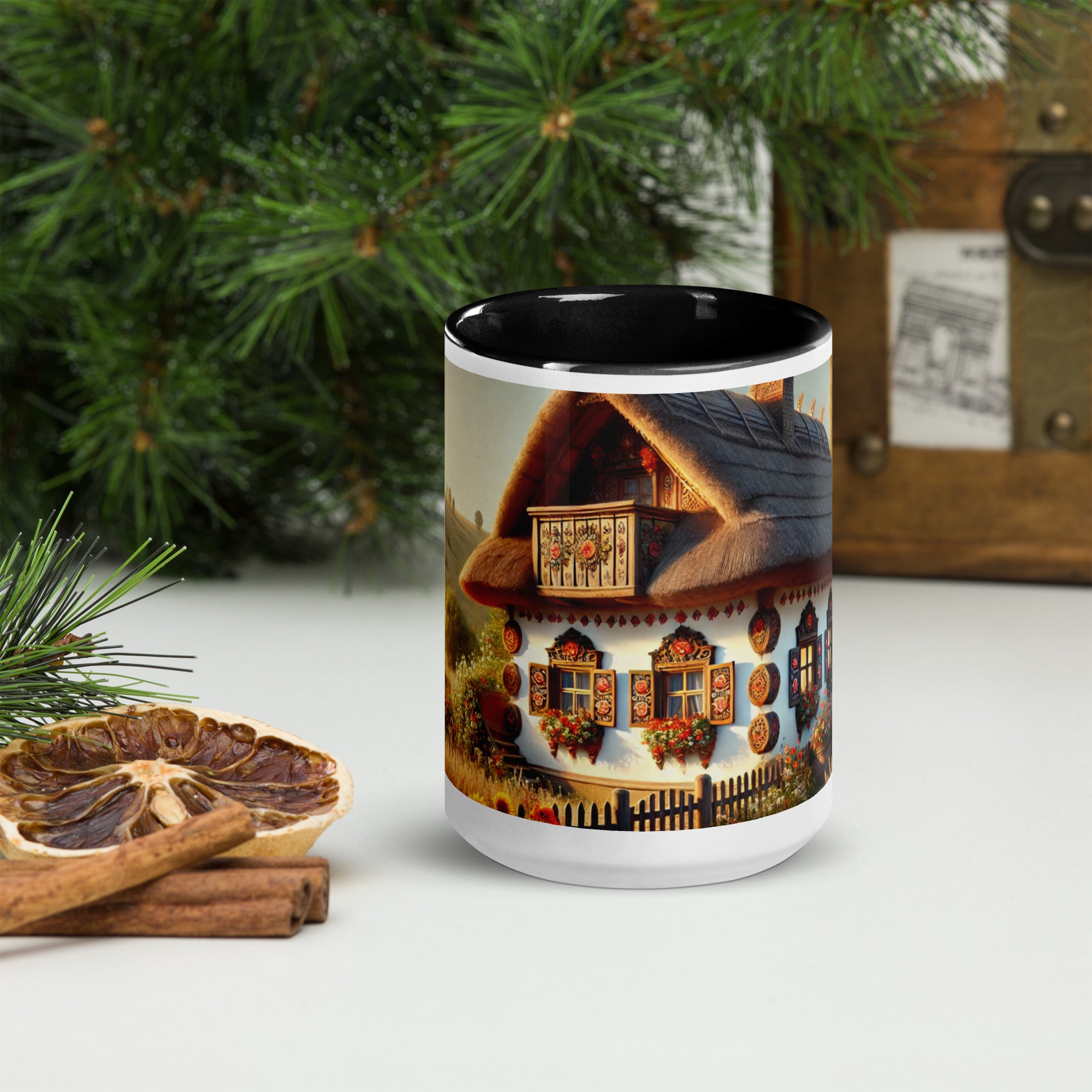 Ukrainian cottage ceramic mug with scenic yard design, featuring colorful accents, placed near pine branches and dried citrus.