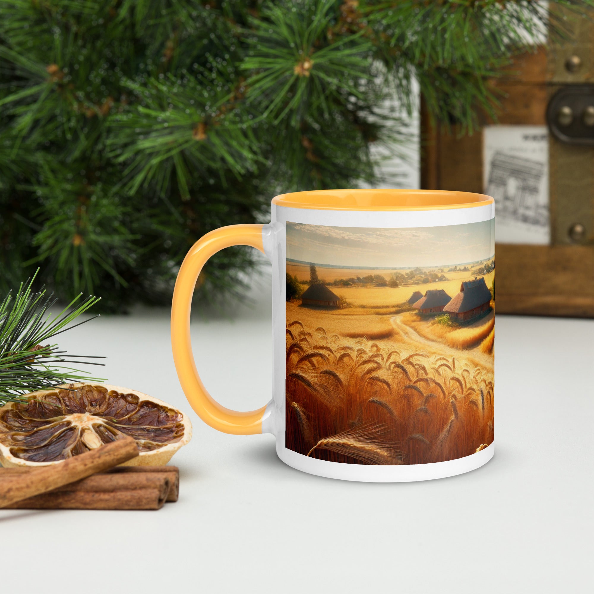 Ceramic mug with Ukrainian cottage and wheat field design, featuring yellow rim and handle, placed on a rustic table setting.