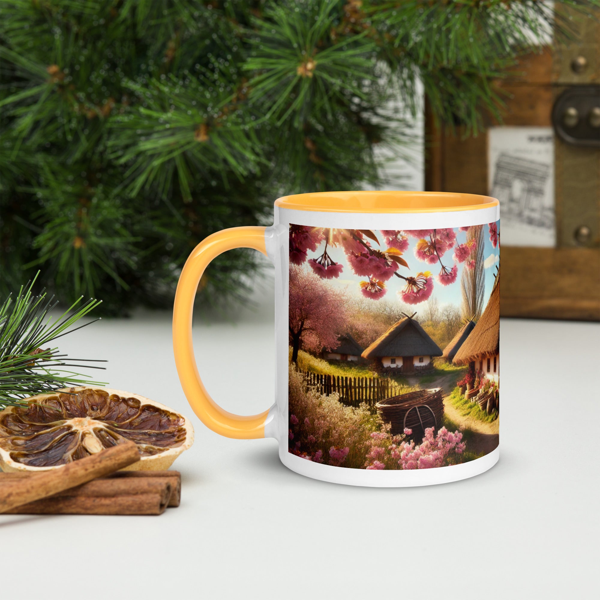"Ukrainian Cottage Mug with Cherry Orchard Design and Yellow Accent, 15 oz Ceramic, Pictured with Cinnamon Sticks and Pine."