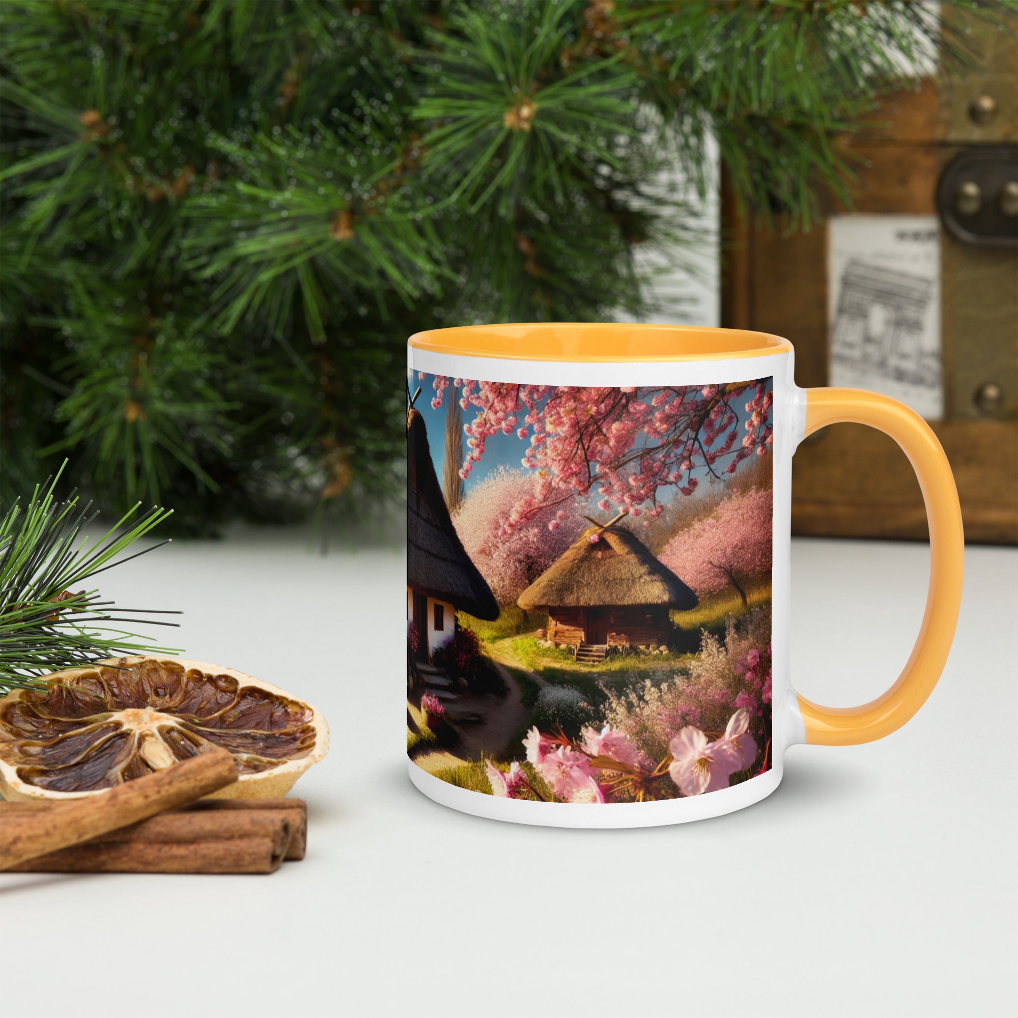 Ceramic mug with Ukrainian cottage and cherry orchard design, featuring a vibrant yellow handle and rim on a festive table setting.