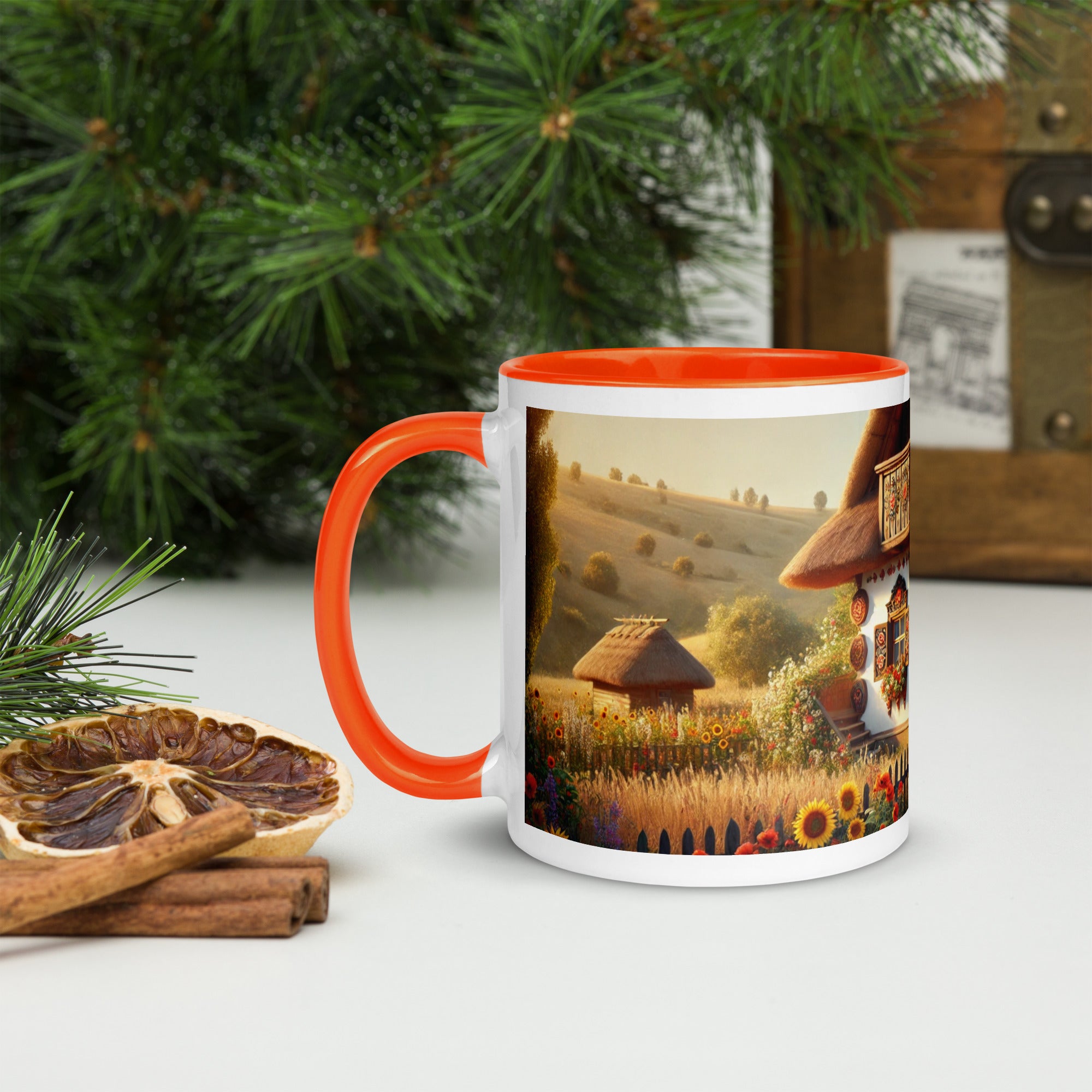Ceramic mug with Ukrainian cottage and scenic yard design, red handle, surrounded by holiday decor, perfect for coffee or tea.