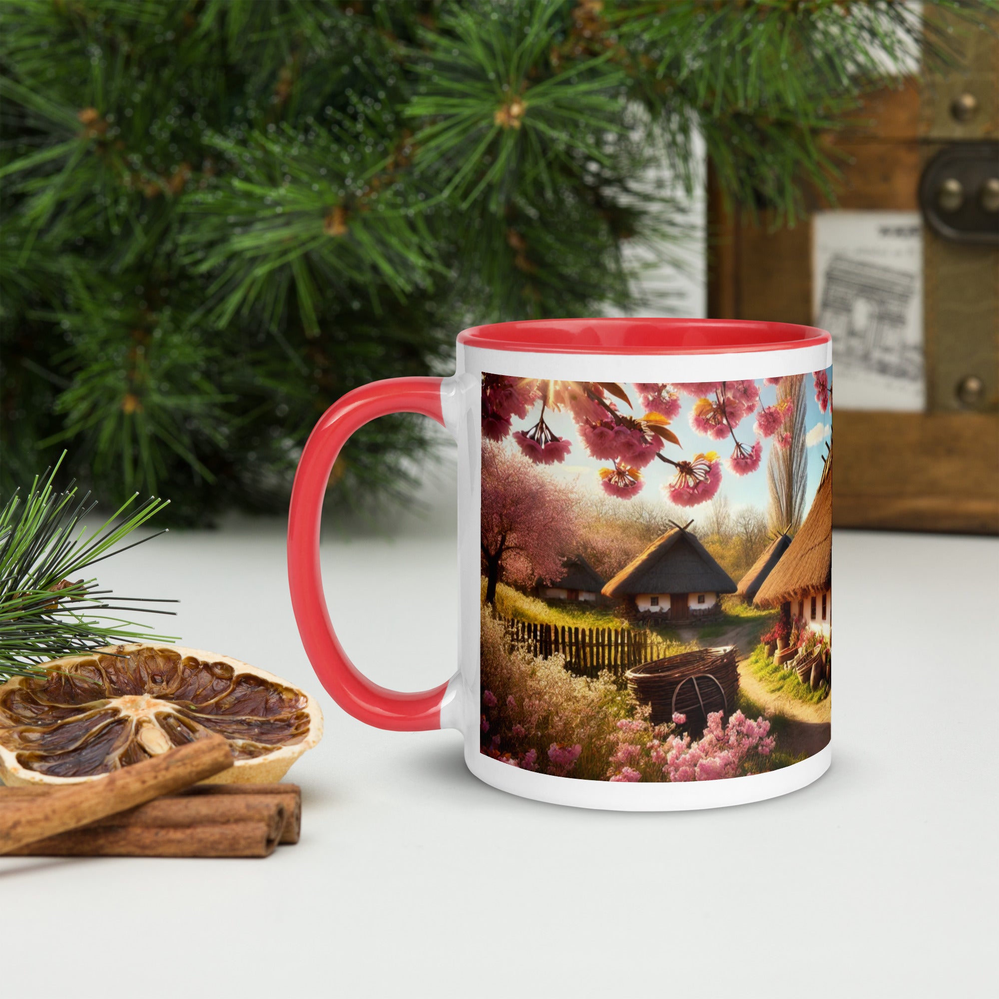 Ceramic mug with Ukrainian cottage and cherry orchard design, red rim and handle, on a festive table setting with dried fruits.