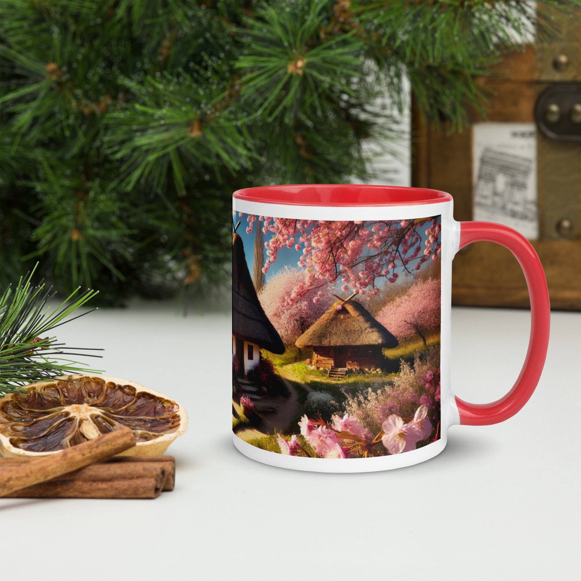 Ceramic mug with Ukrainian cottage and cherry orchard design, featuring a red rim and handle, surrounded by pine branches and spices.