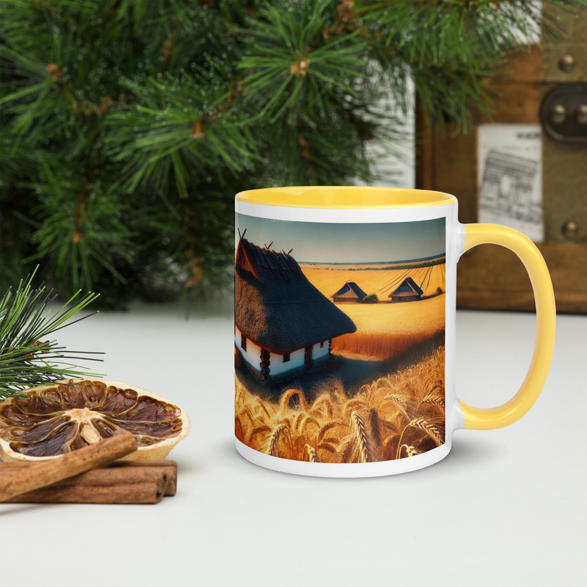 Ceramic mug with Ukrainian cottage and wheat field design, featuring a yellow rim and handle, on a festive table setting.
