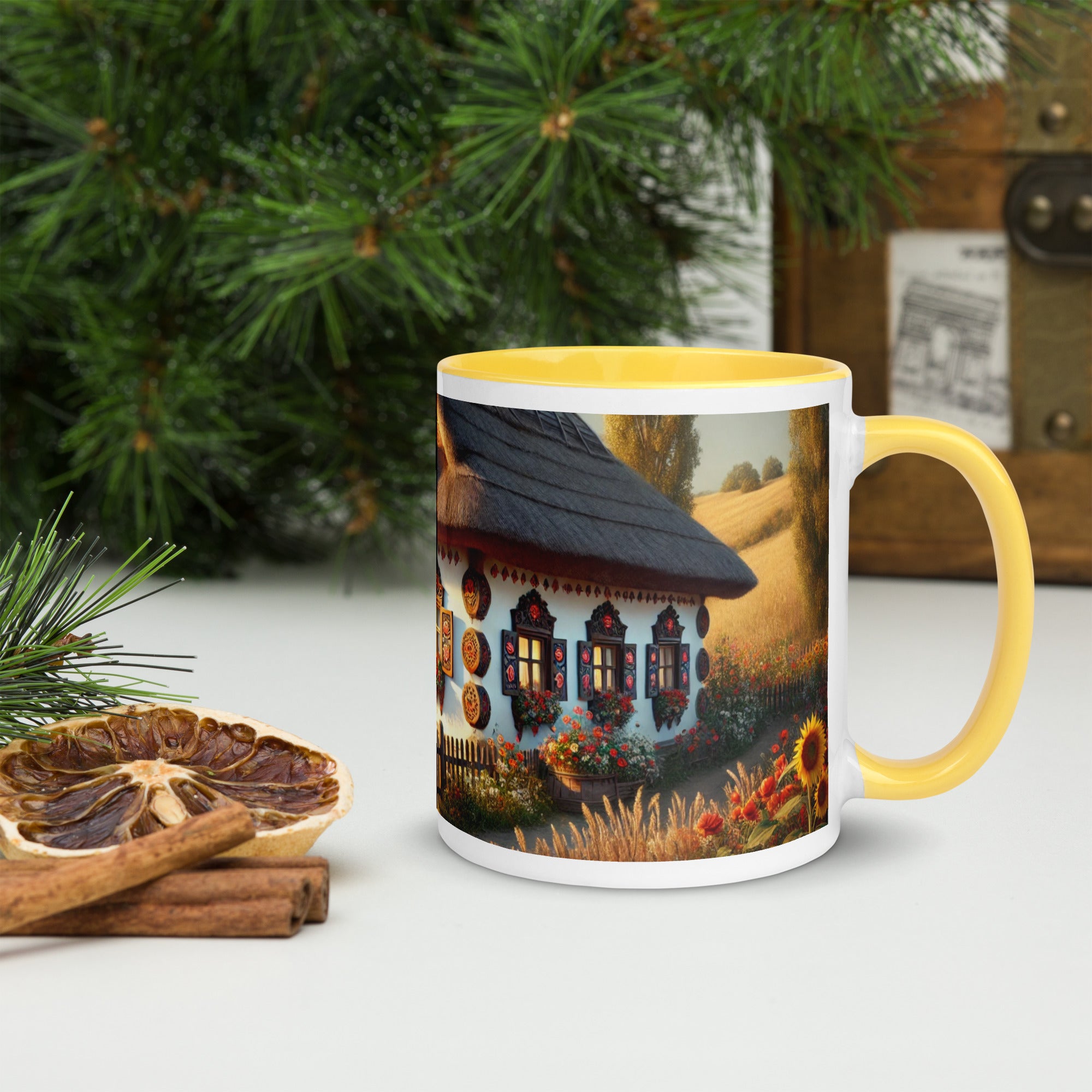 Ceramic mug with Ukrainian cottage and scenic yard design, yellow rim and handle, surrounded by greenery and rustic decor.