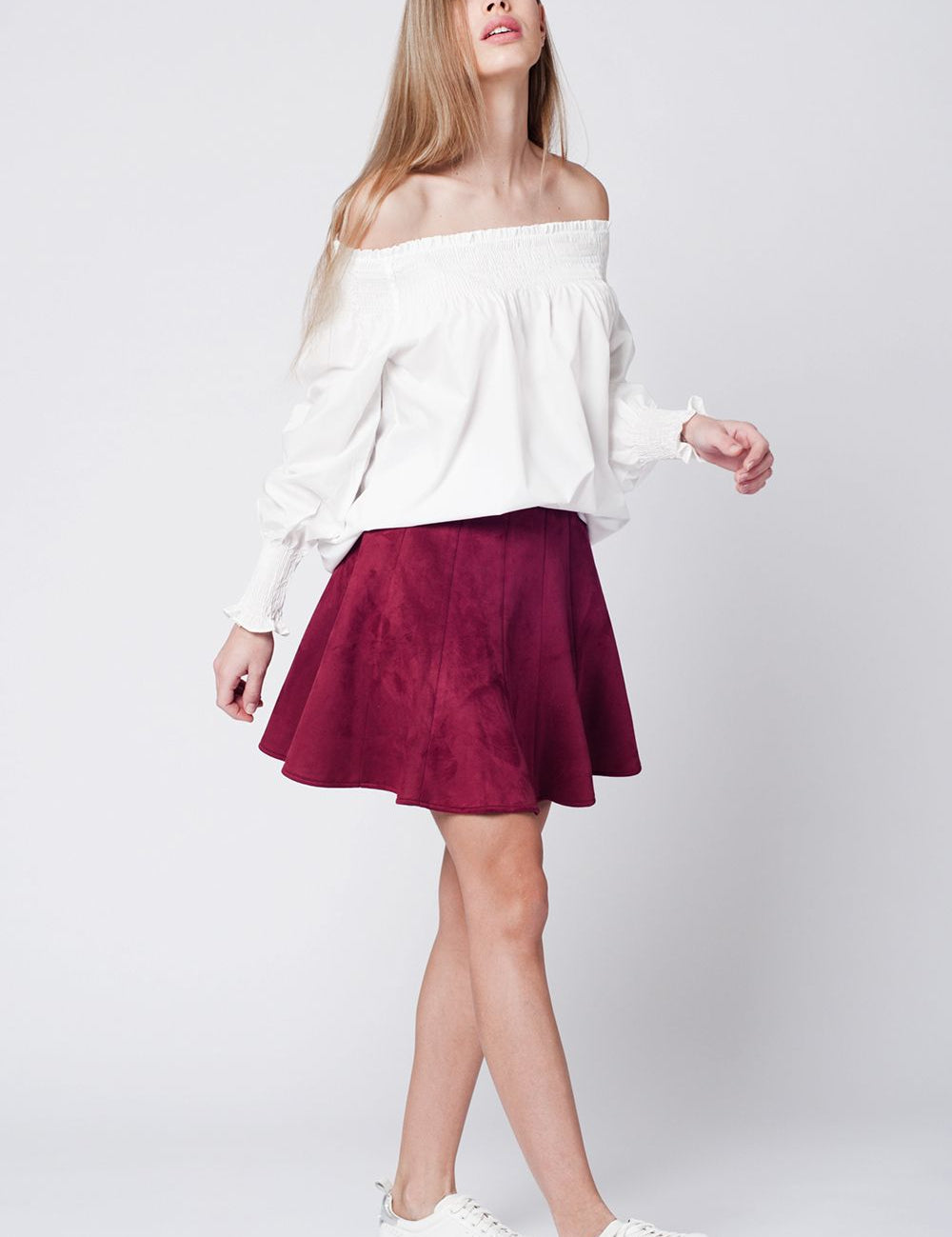 Woman wearing Calvera Poplin Shoulder Top with a red skirt and white sneakers, showcasing modern style and tailored fit.