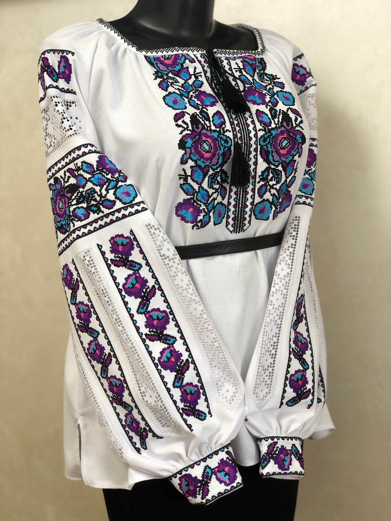 White homespun embroidered vyshyvanka blouse with traditional Ukrainian floral and geometric cross-stitch design for women.