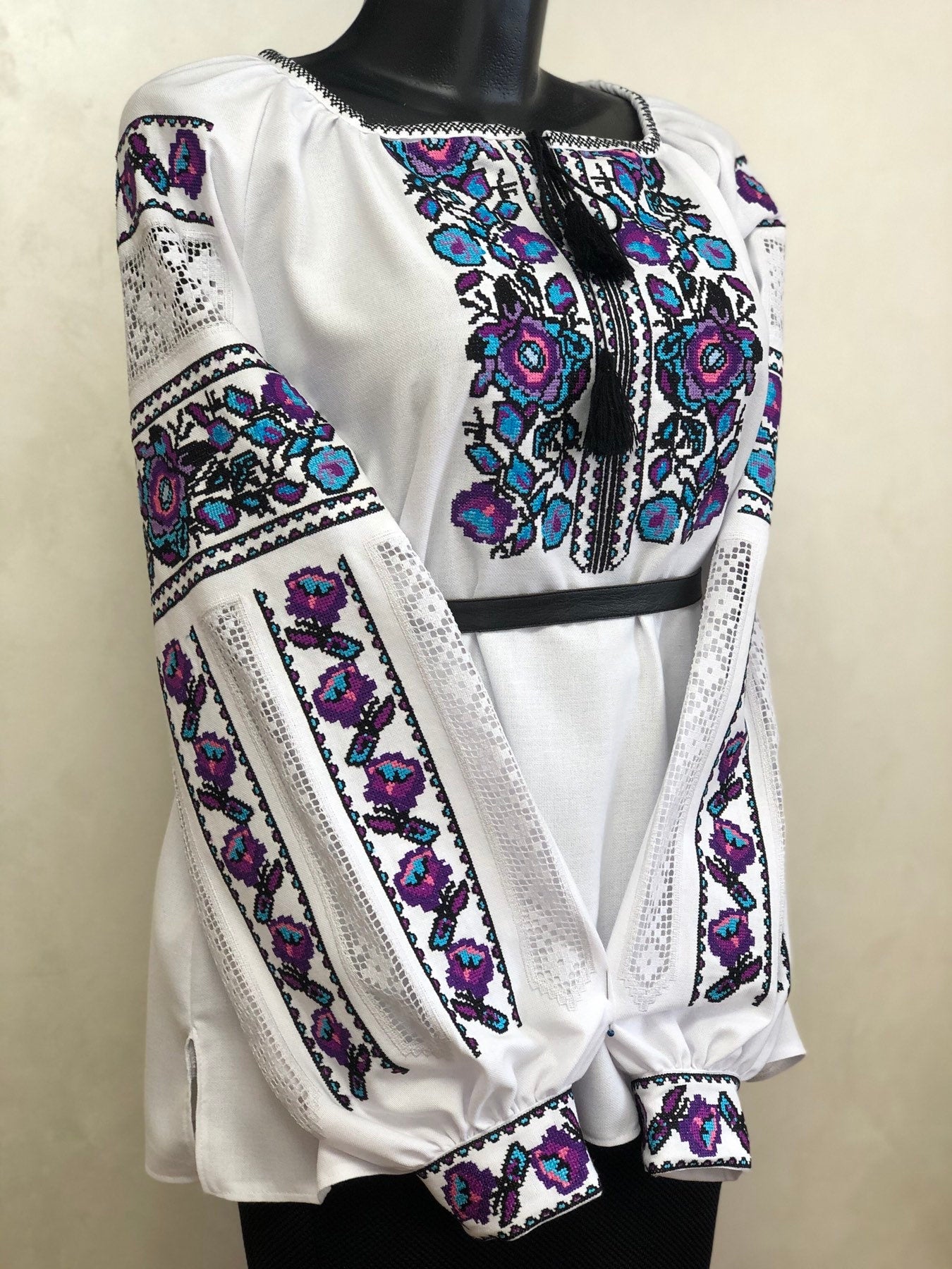White homespun embroidered vyshyvanka, traditional Ukrainian blouse with colorful cross-stitch floral patterns for women.