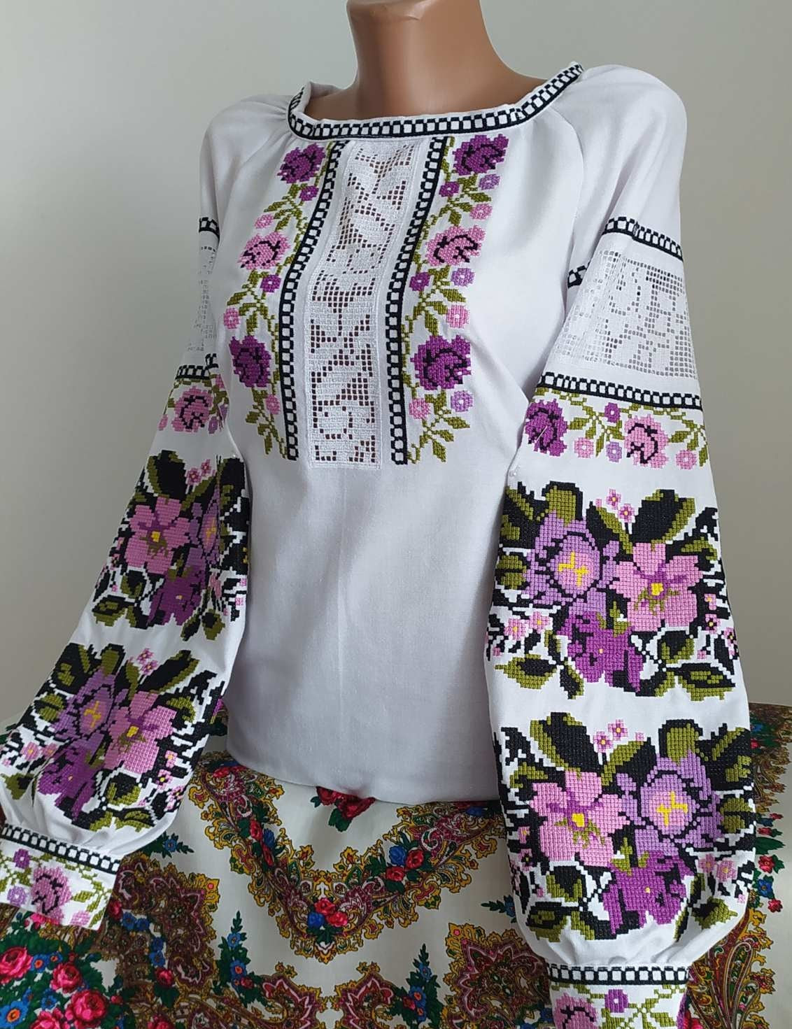 White homespun Vyshyvanka blouse with Ukrainian embroidery, showcasing floral patterns on natural fabric for women.