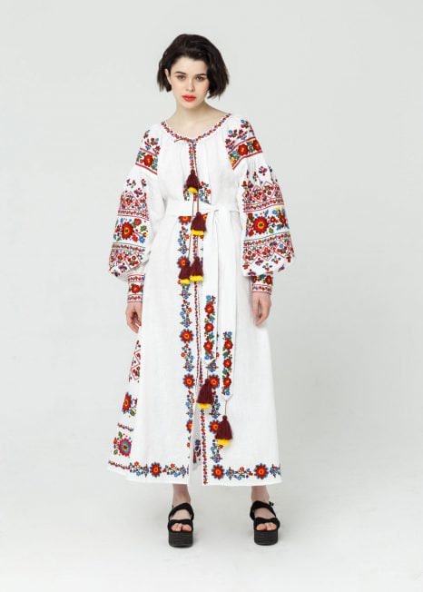 Elegant white linen embroidered wedding dress, Ukrainian Vibe Vyshyvanka in boho style, featuring intricate red and black folk patterns.