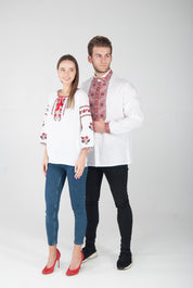 Man and woman wearing Ukrainian embroidered vyshyvanka blouses with red ornament, showing cultural heritage fashion style.