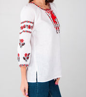 White linen blouse with red Ukrainian embroidery on sleeves and chest, featuring traditional folk design for women.