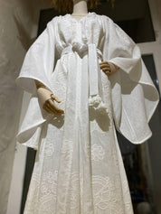 Elegant white linen wedding dress with Ukrainian boho embroidery, perfect gift for her, featuring subtle floral patterns.