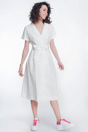 Woman wearing Calviera Belted Poplin Shirt Dress with structured white cotton design and tailored collar.