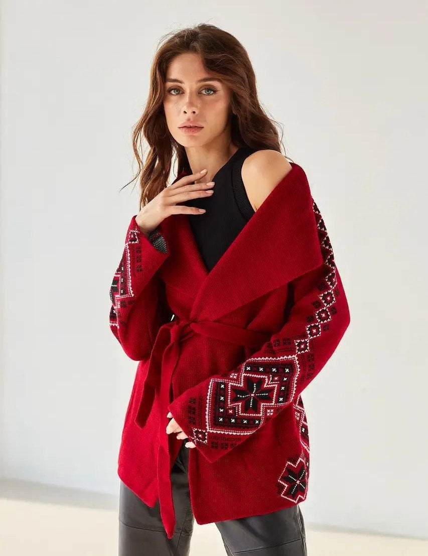Women's boho knit cardigan with Ukrainian ornaments, oversized red wrap sweater, stylish winter fashion.