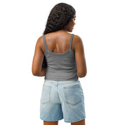 Woman wearing gray micro-rib tank top from Ukrainian Vibe Trizub Collection with denim shorts, showing back view.