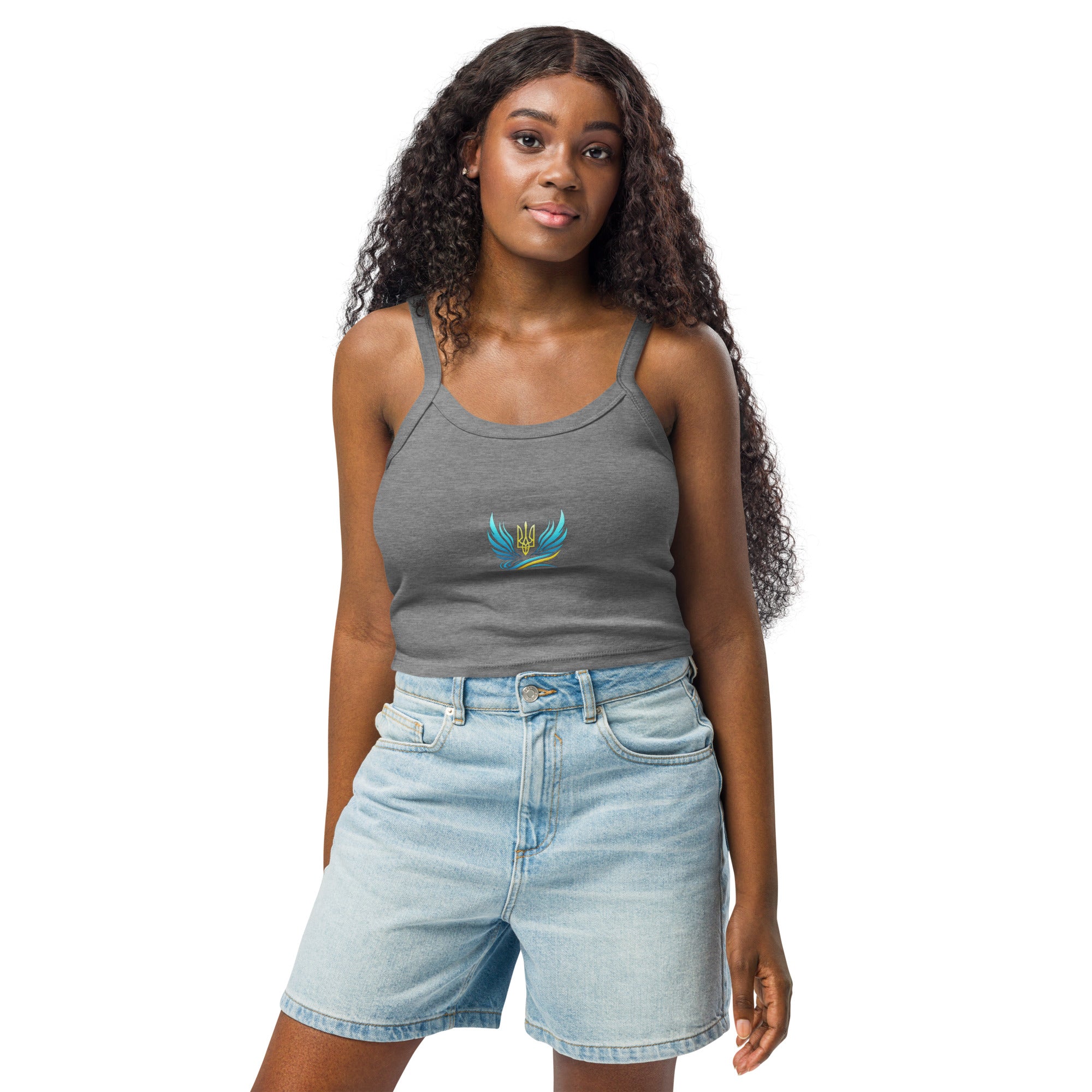 Woman wearing grey tank top from Ukrainian Vibe Trizub Collection with denim shorts, showcasing casual chic style.