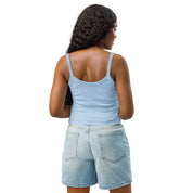 Woman wearing a light blue micro-rib tank top with denim shorts, showcasing the back design of the Ukrainian Vibe Trizub Collection.