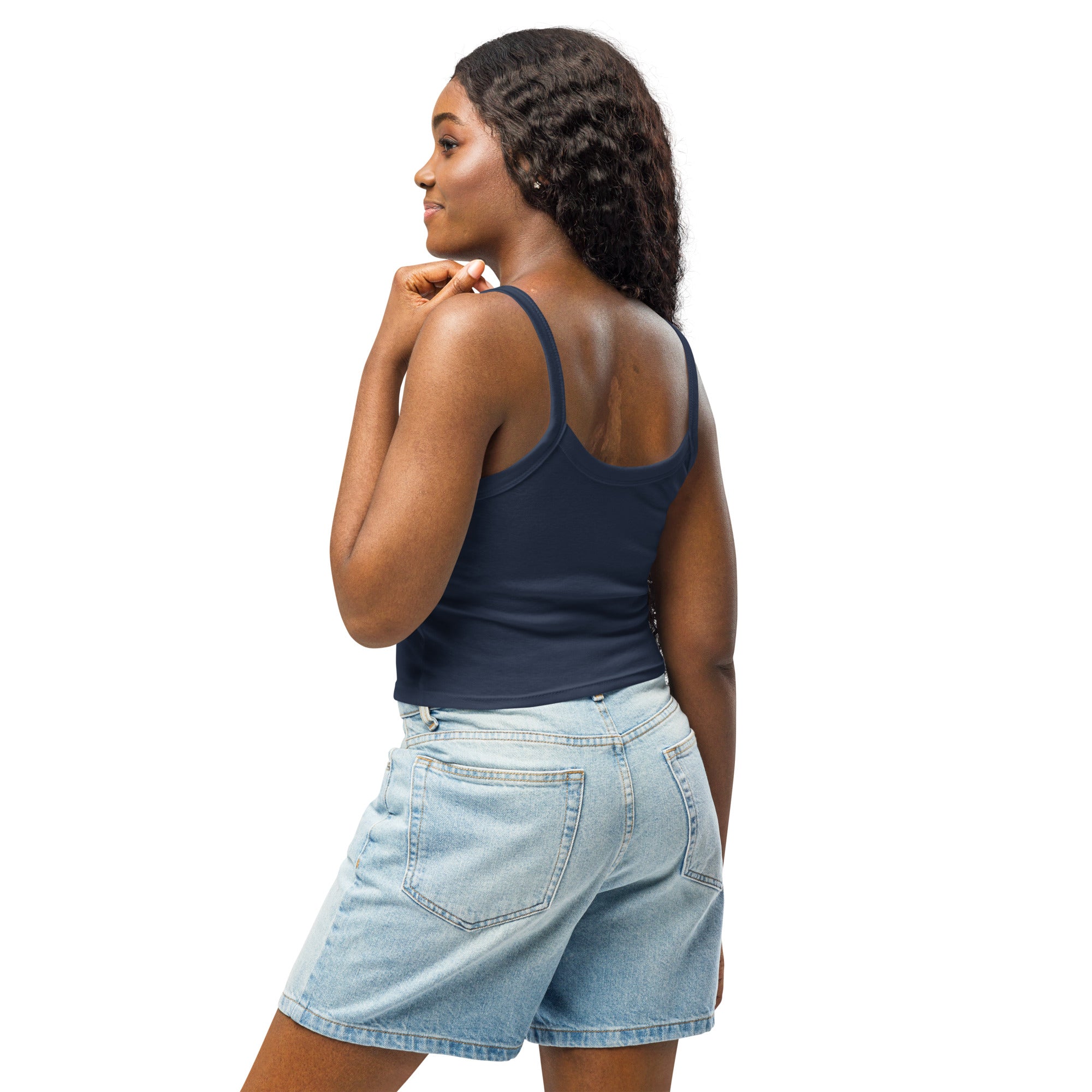 Woman wearing navy tank top from Ukrainian Vibe Trizub Collection, paired with denim shorts, showcasing stylish and comfortable summer fashion.