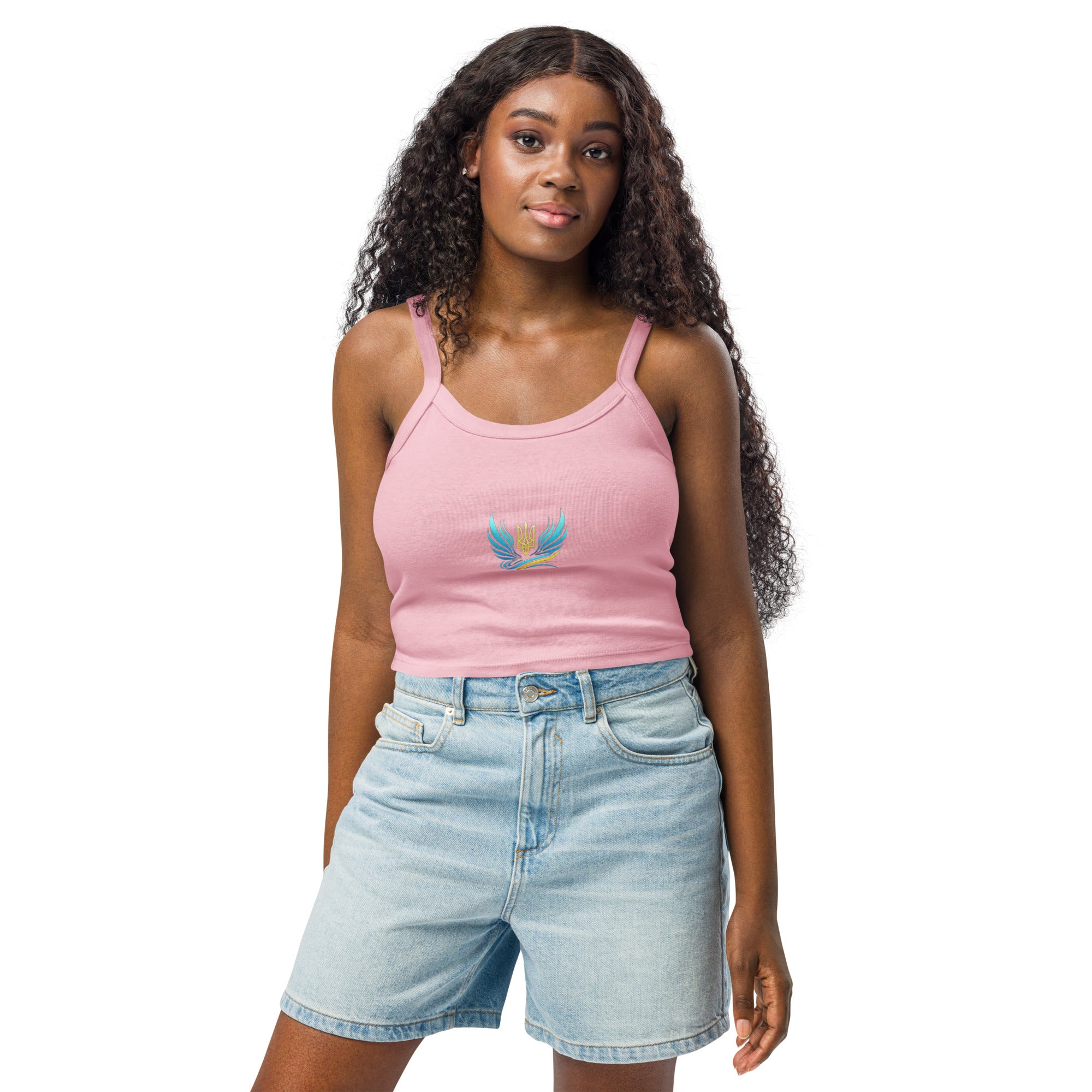 Woman wearing Ukrainian Vibe Trizub Collection pink micro-rib tank top with denim shorts, showcasing a casual and chic style.