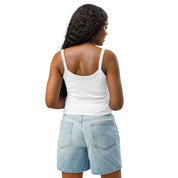 Woman wearing Ukrainian Vibe Trizub Collection micro-rib tank top in white, paired with denim shorts, showcasing back view.