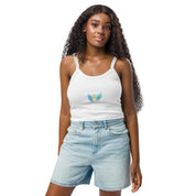 Woman wearing Ukrainian Vibe Trizub Collection micro-rib tank top in white, paired with denim shorts, showcasing chic and casual style.