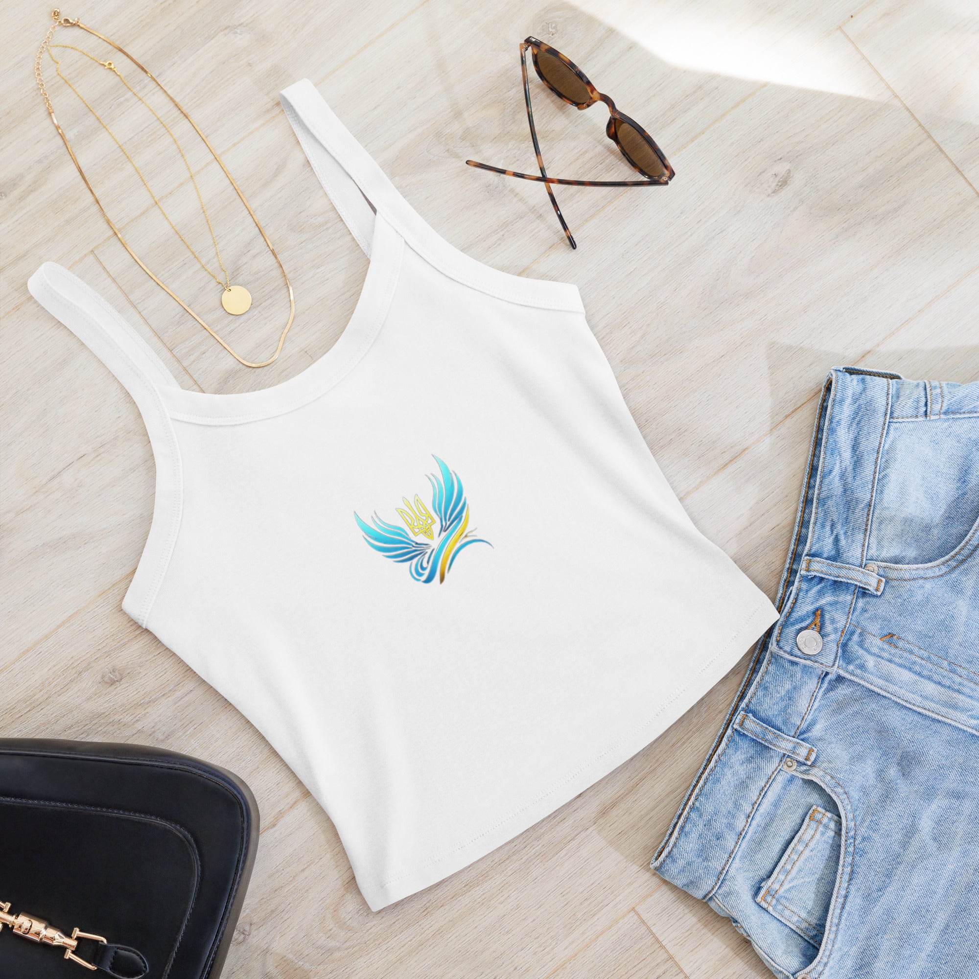 White micro-rib tank top with Ukrainian Vibe Trizub design, paired with jeans, sunglasses, necklace, and black bag on wooden floor.
