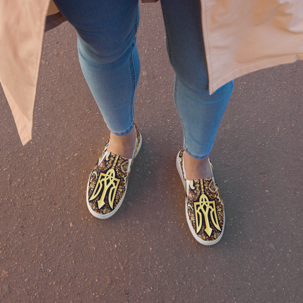 Woman wearing slip-on canvas shoes with Ukrainian symbols and jeans on a sidewalk.