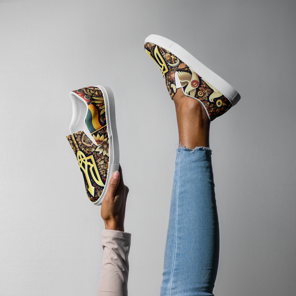 Women's slip-on canvas shoes with Ukrainian symbolic design, held against a white background, worn with blue jeans.